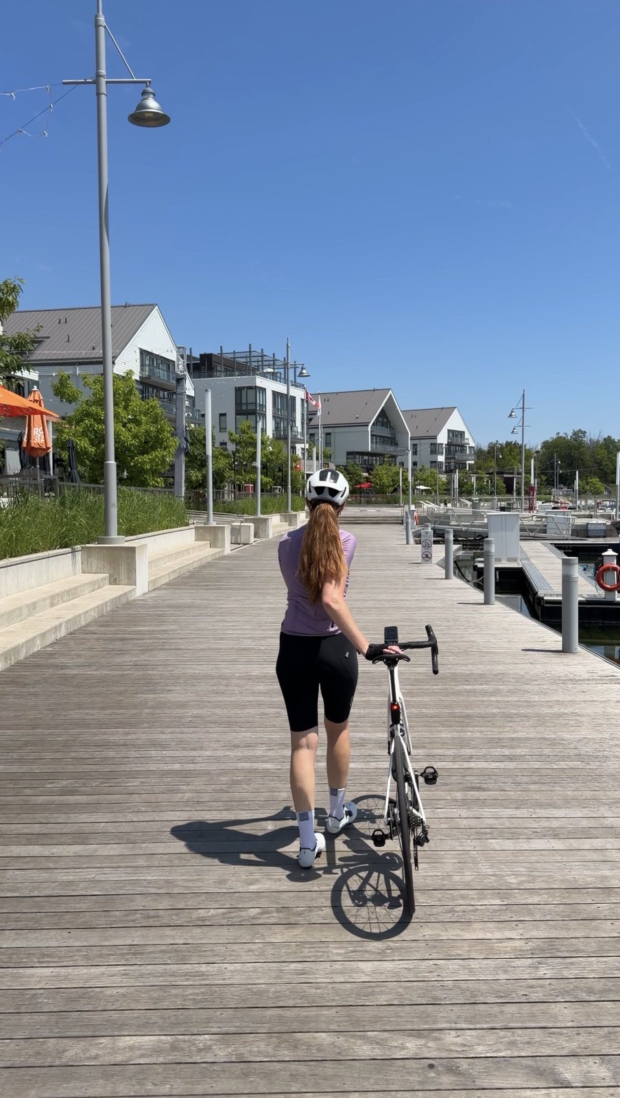 Bailey walking her bike along the Friday Harbour marina boardwalk
