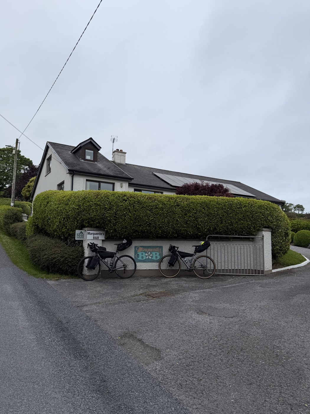 The two loaded bikes at the entrance sign of Marguerite's B&B outside Skibbereen