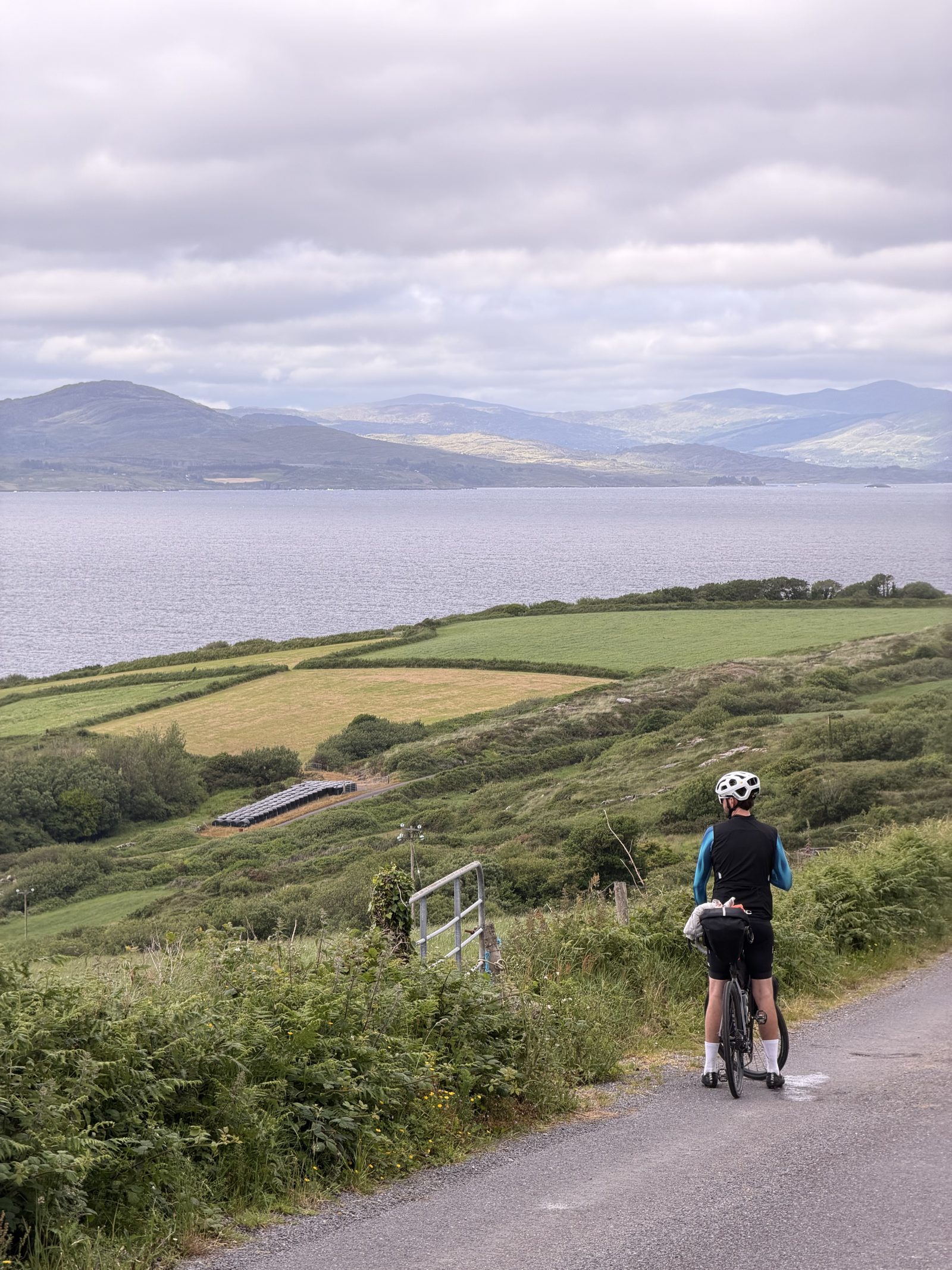 Francis stopped at his bike on a high road, looking out over Bantry Bay to the mountains beyond