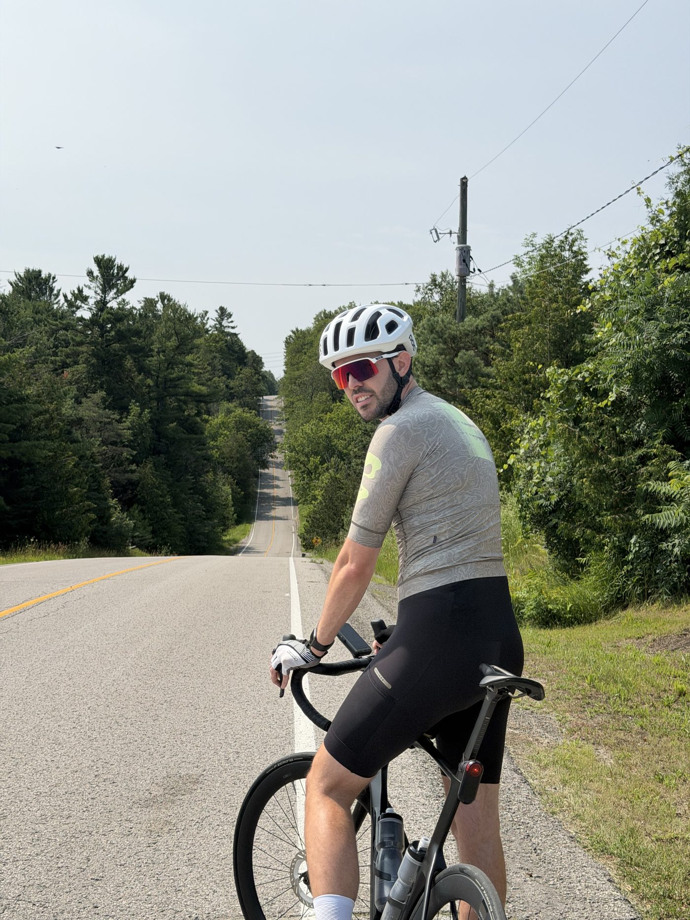 Francis stopped on the bike, looking back over a long rolling road through the countryside