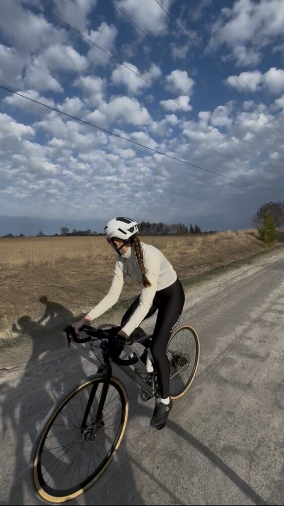 Rider on a gravel concession road under a big cloud sky