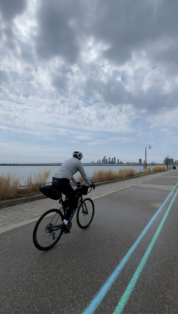 Rider on the Waterfront Trail bike lane toward the city